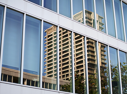 Reflection of University Hall in the windows of Douglas Hall