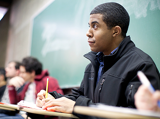 Student taking notes during a class