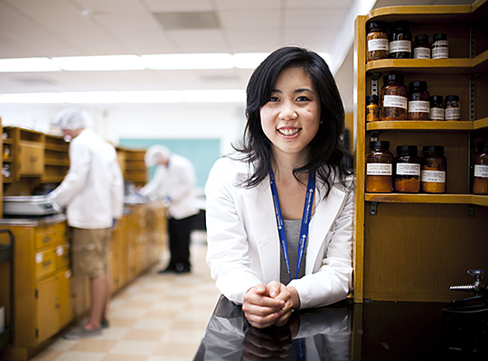 Pharmacy student leaning on a desk in a lab