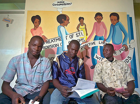 Three Ethiopian men sitting in the waiting room of a clinic